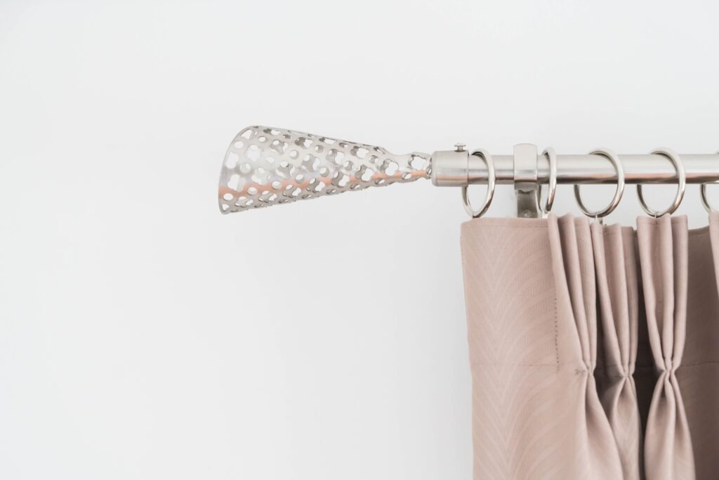 How to Layer Curtains with One Rod – A beautifully styled window featuring sheer and blackout curtains on a single rod, creating a layered and elegant look.