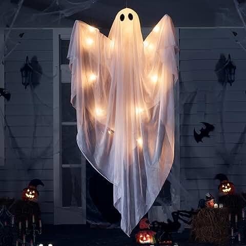 Hanging ghosts that float in the breeze outside a house as part of ghostly Halloween decorations, creating a spooky festive atmosphere